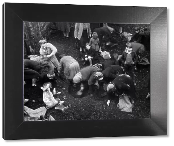 Picture shows women from the Southwark district of London gathering coal from a Bomb site