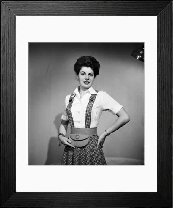 Framed Print : Woman wearing a pinafore dress and holding a purse November 1952 C6272 Framed Print : Woman wearing a pinafore dress and holding a purse November 1952 C6272