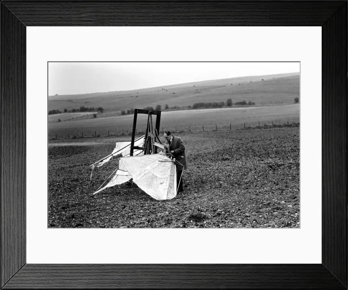 Framed Print : A man trues out his home made flying machine in a field in Wiltshire Framed Print : A man trues out his home made flying machine in a field in Wiltshire