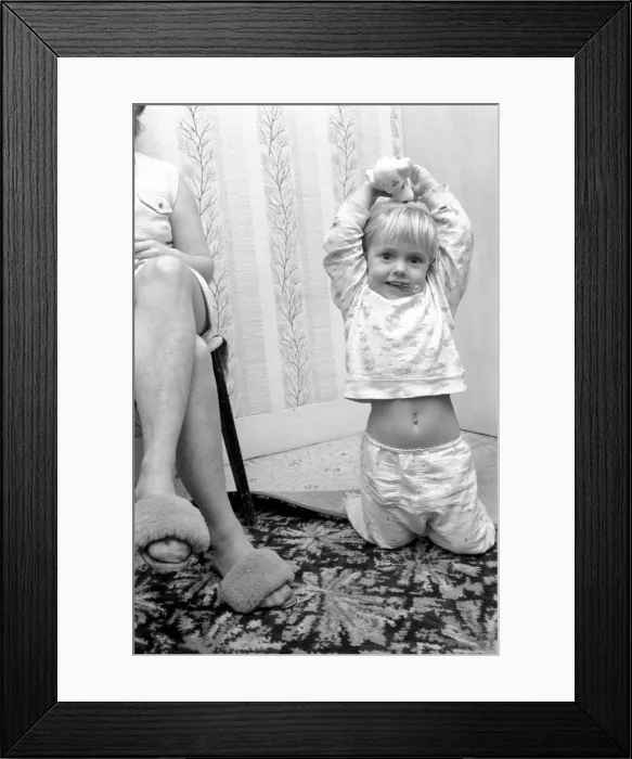 Framed Print : Three year old girl playing at home. November 1969 Z10847