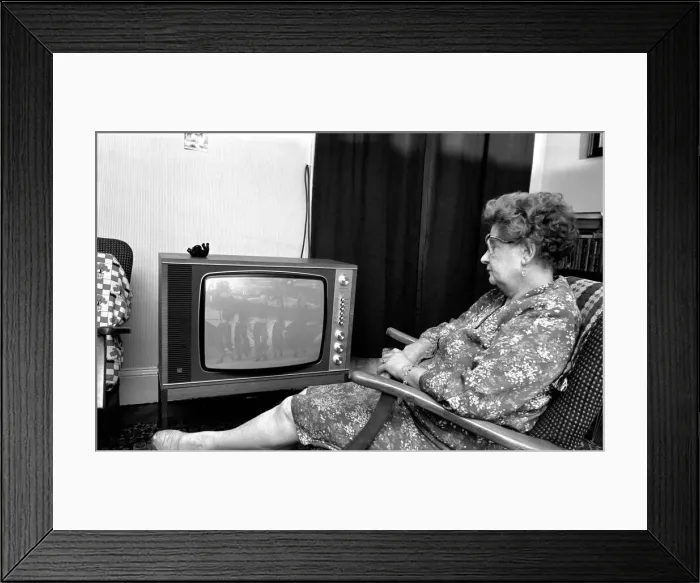Framed Print : Mrs. Christina Teatheredge of South West London watches Z cars in black Framed Print : Mrs. Christina Teatheredge of South West London watches Z cars in black