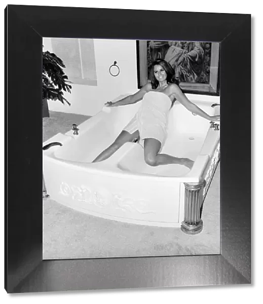 Woman using a bath designed for two people. November 1969 Z10586-003