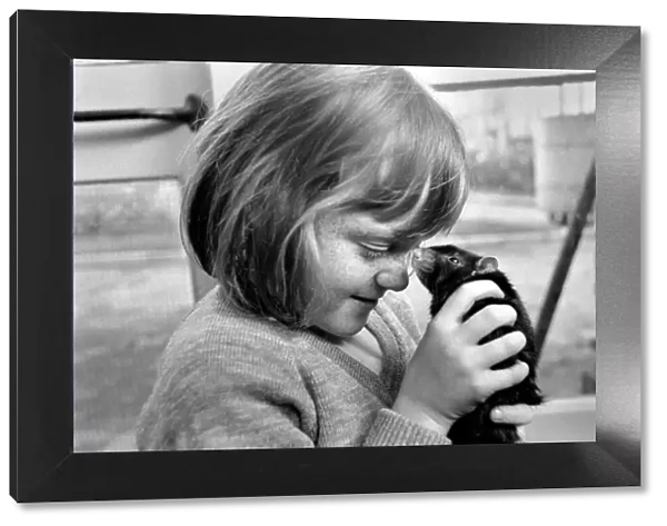 Little girl holding a rat. November 1969 Z10521-003