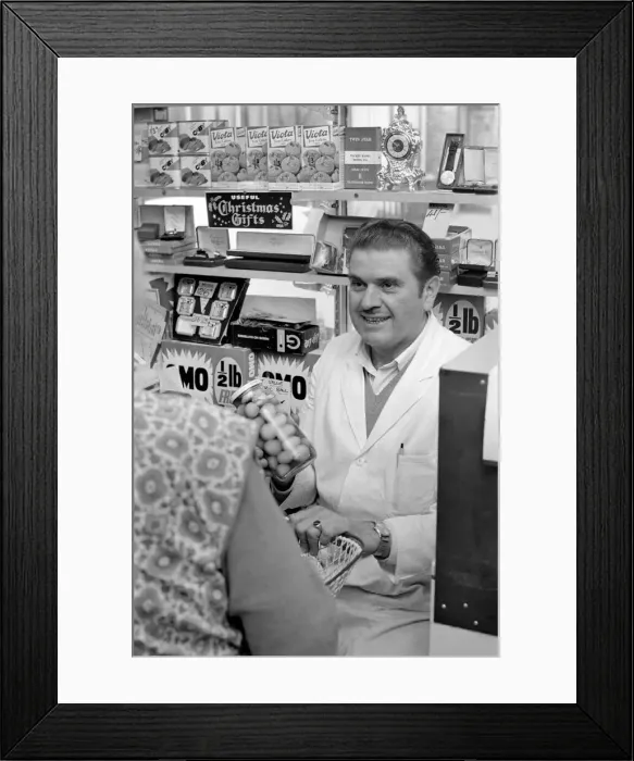 Framed Print : A man serving a customer in his shop at Deptford. November 1969 Z10715-004 Framed Print : A man serving a customer in his shop at Deptford. November 1969 Z10715-004