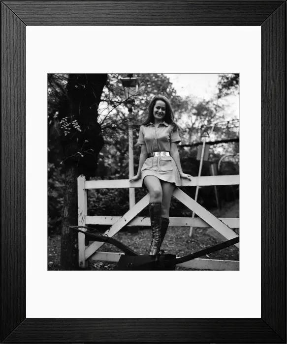 Framed Print : Woman wearing mini dress with belt across the waist and knee high boots