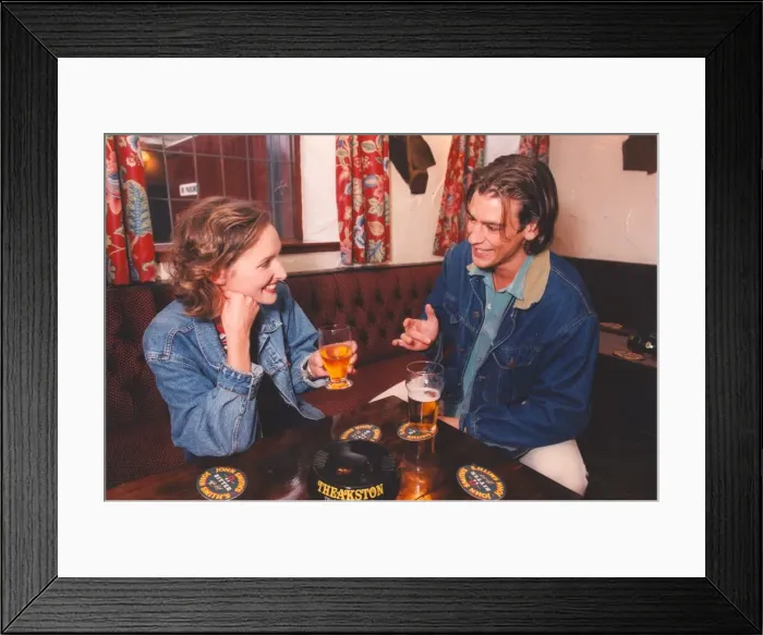 Framed Print : A couple enjoying a night out in a bar pub Framed Print : A couple enjoying a night out in a bar pub