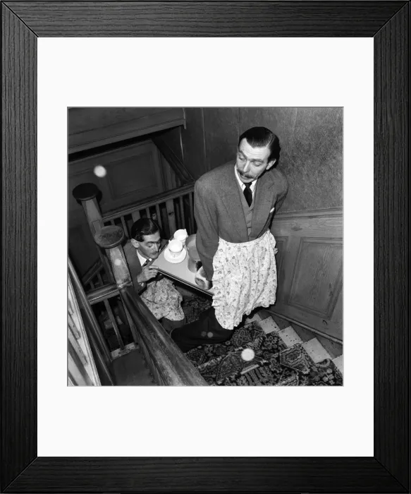 Framed Print : BBC comedy scriptwriters Frank Muir and Denis Norden bringing a tray of tea up the stairs Framed Print : BBC comedy scriptwriters Frank Muir and Denis Norden bringing a tray of tea up the stairs