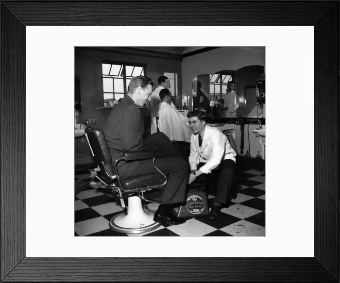 Framed Print : Terence O Neill at work as a shoe-shine boy in the barbers shop at the American Air Framed Print : Terence O Neill at work as a shoe-shine boy in the barbers shop at the American Air