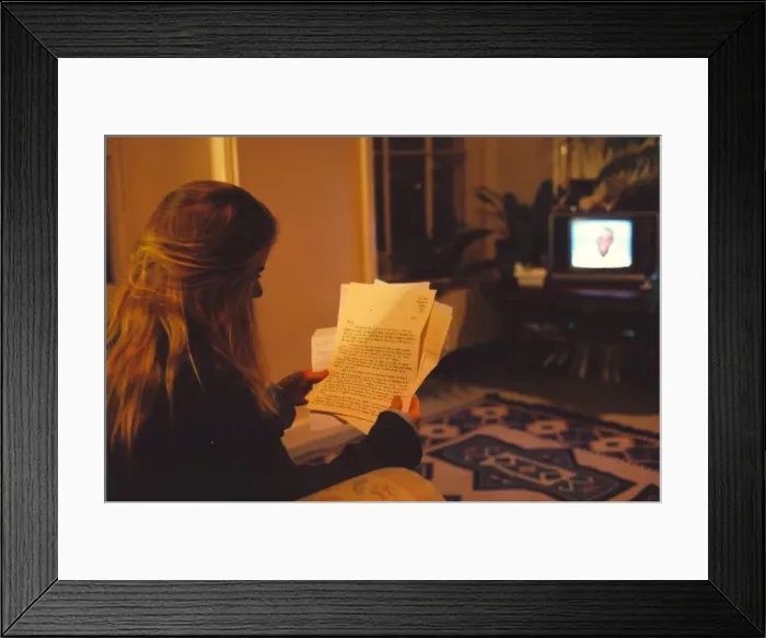 Framed Print : A woman looking throught her replys to a Lonley Hearts advert Framed Print : A woman looking throught her replys to a Lonley Hearts advert