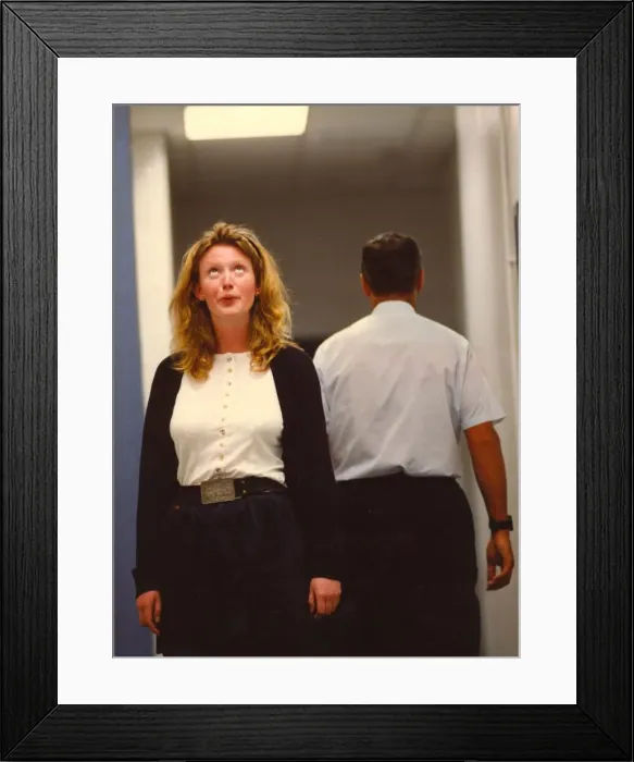 Framed Print : A woman swoons over a male colleague