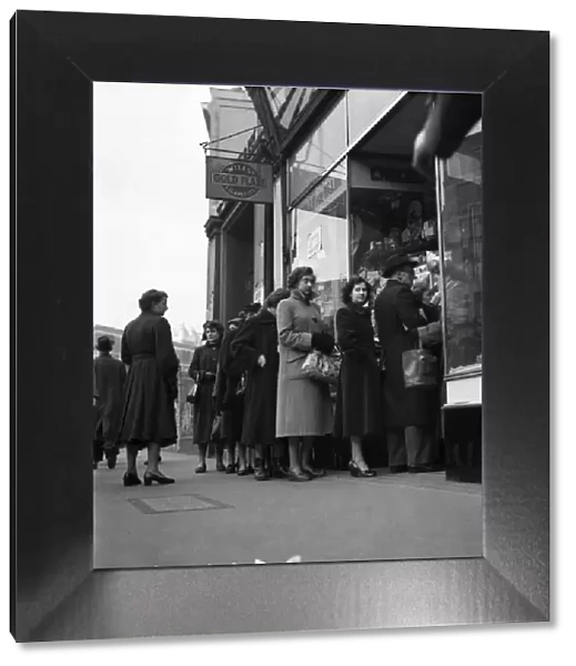 People queuing up outside a confectioney shop after sweets came off the ration following