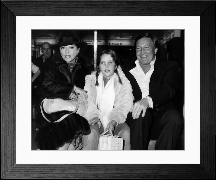 Framed Print : Joan Collins with her husband and her daughter at Heathrow on their way back to San Framed Print : Joan Collins with her husband and her daughter at Heathrow on their way back to San