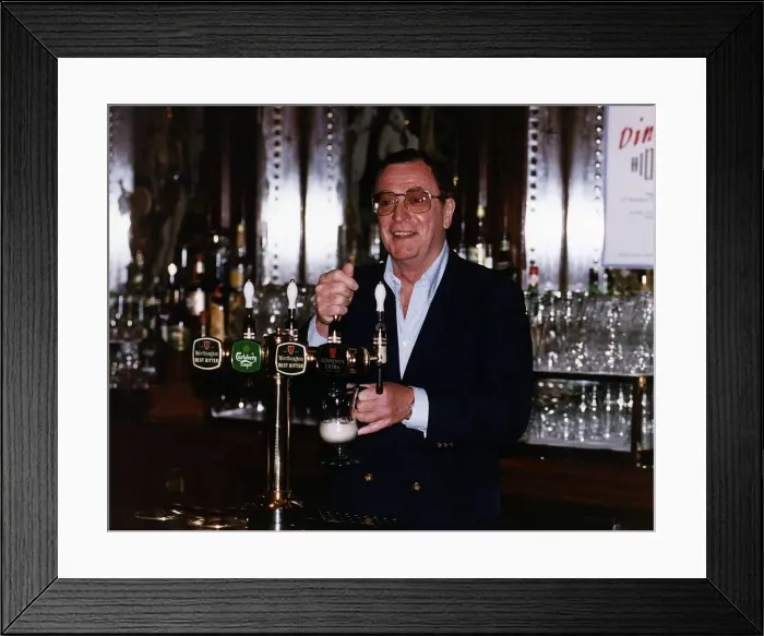 Framed Print : Michael Caine serving behind a bar Framed Print : Michael Caine serving behind a bar