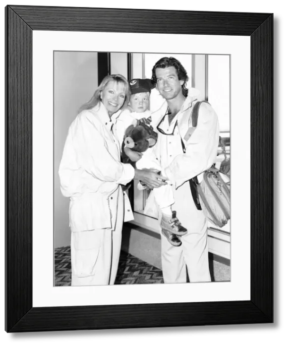Framed Print : Pierce Brosnan actor with his wife and son at Heathrow airport Framed Print : Pierce Brosnan actor with his wife and son at Heathrow airport
