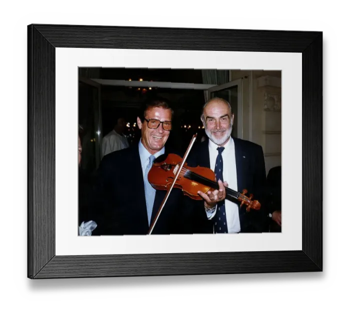 Framed Print : Sean Connery and Roger Moore actors from James Bond films meet whilst Roger plays Framed Print : Sean Connery and Roger Moore actors from James Bond films meet whilst Roger plays