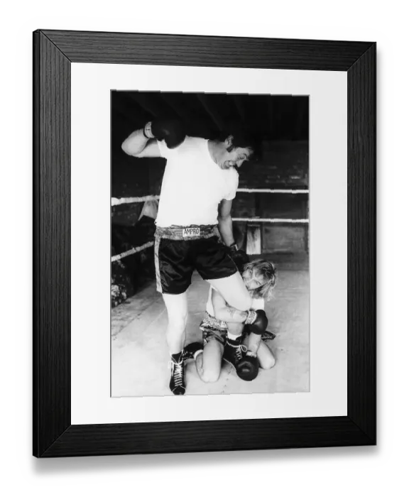 Framed Print : Freddie Starr biting the leg of Dick Richardson his road manager