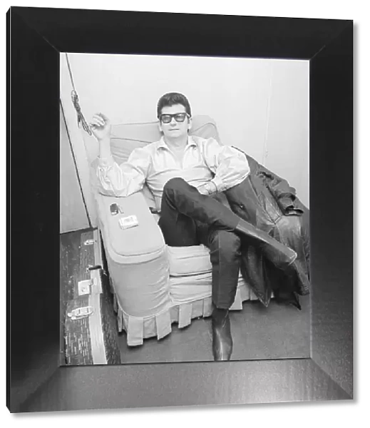 Roy Orbison, the American singer, relaxes in his dressing room before going on stage at