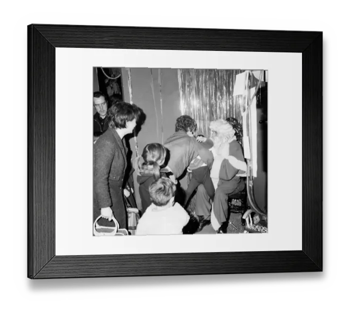 Framed Print : Christmas Humour - Santa. Mother deposits a reluctant child to sit on the knee of