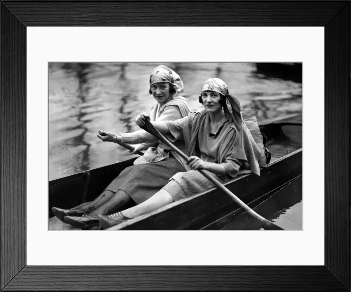 Framed Print : Two girls rowing a boat in a London park as the sun comes out, May 1945