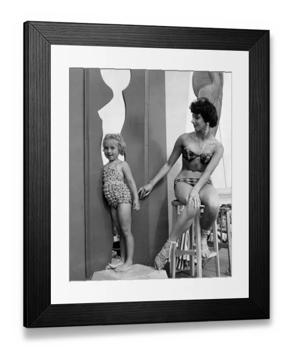 Framed Print : Sunday; Picture; Beach Beauty prize contest: A tiny onlooker tries out the cut outs