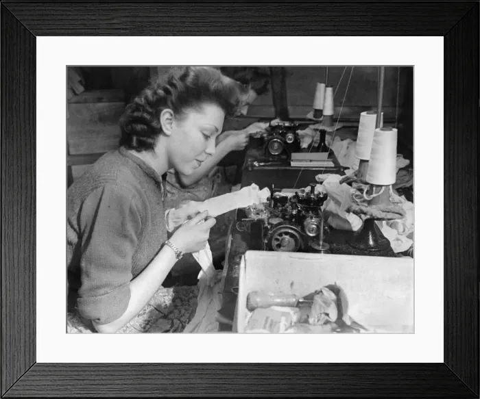 Framed Print : Clothing Stockings. This girl puts seams in stockings at the rate of 4 Framed Print : Clothing Stockings. This girl puts seams in stockings at the rate of 4