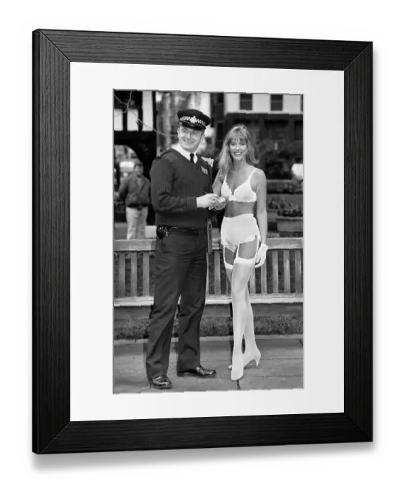 Framed Print : Lingerie that changes colour with your mood. Model in lingerie with policeman