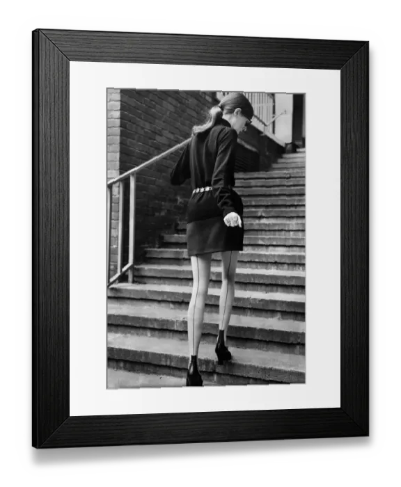 Framed Print : Clothing - Stockings Seamed stockings feature. Model walks up steps