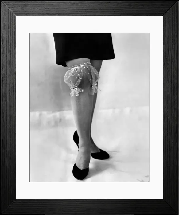 Framed Print : Clothing stockings. Woman models garter. September 1957 P018455
