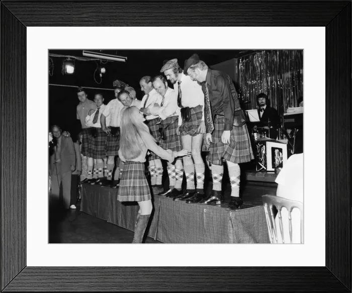 Framed Print : Off with their trousers! A line-up of phoney Scots in the Caledonian Suite night club