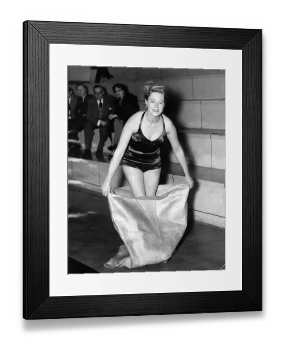 Framed Print : Views - Swimsuits, unsinkable. Woman wearing halterneck swimming costume steps into a Framed Print : Views - Swimsuits, unsinkable. Woman wearing halterneck swimming costume steps into a