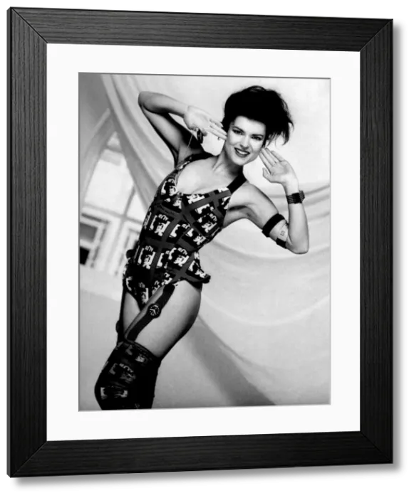 Framed Print : Clothing Beach. Woman models underwear and stockings held together with a watch