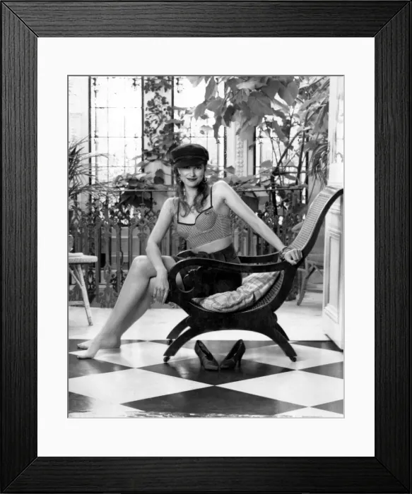 Framed Print : Clothing Underwear. Model wearing bra top, shorts and hat sitting in chair Framed Print : Clothing Underwear. Model wearing bra top, shorts and hat sitting in chair