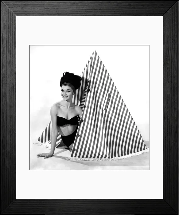Framed Print : Clothing Beach 1963. Model Merril Weston shows how to use the striped cape-tent Framed Print : Clothing Beach 1963. Model Merril Weston shows how to use the striped cape-tent