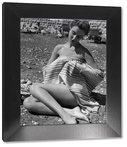 Undressing on the beach with aid of a towel has been made easy by simple device
