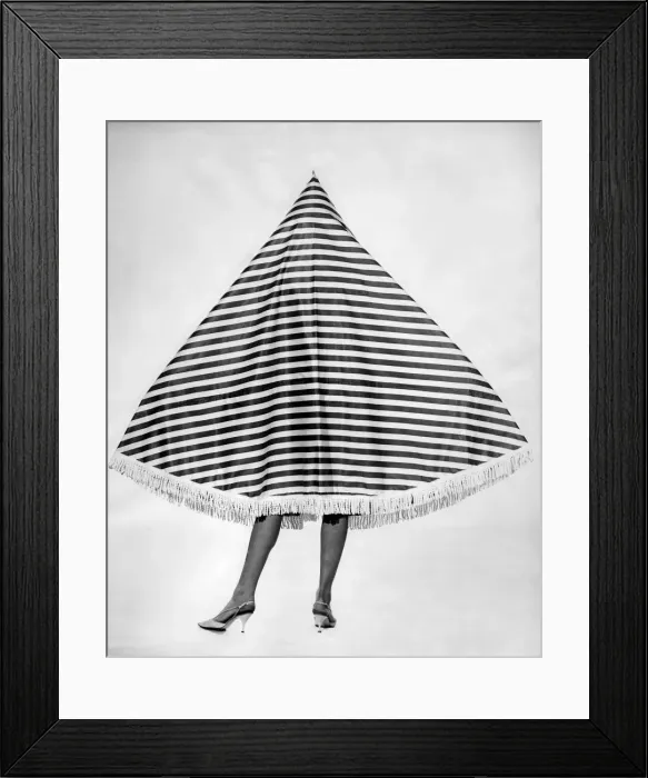 Framed Print : Clothing Beach 1963. Model Merril Weston wears a striped cape-tent