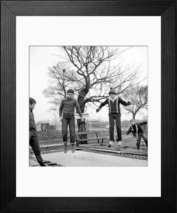 Framed Print : Children playing on trampolines in the adventure playground at Basildon, Town centre Framed Print : Children playing on trampolines in the adventure playground at Basildon, Town centre
