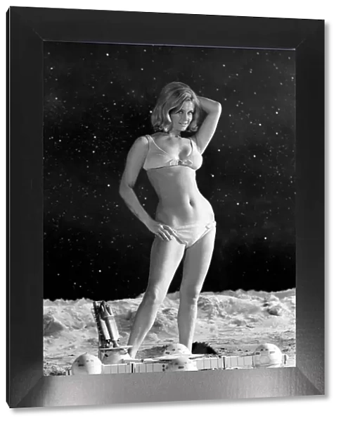 Model June Cooper poses for pictures with a backdrop designed as the surface of the moon
