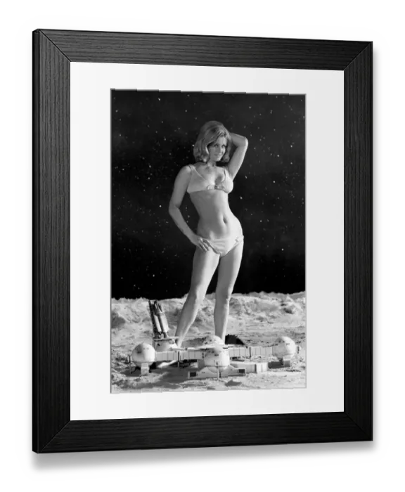 Framed Print : Model June Cooper poses for pictures with a backdrop designed as the surface of the moon