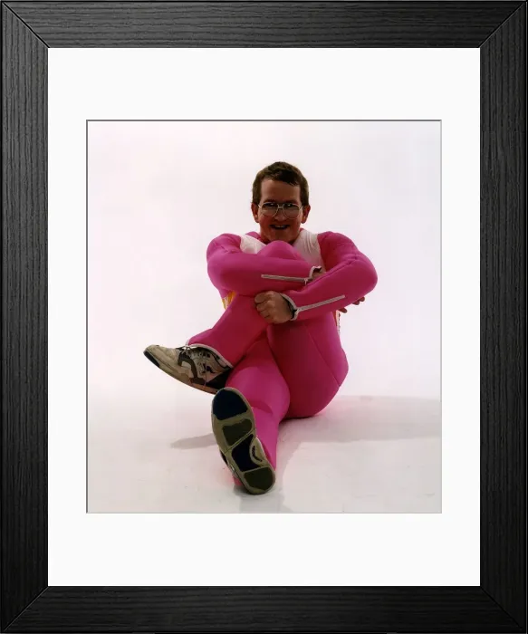 Framed Print : Eddie Edwards ski jumper sitting in pink ski suit Framed Print : Eddie Edwards ski jumper sitting in pink ski suit