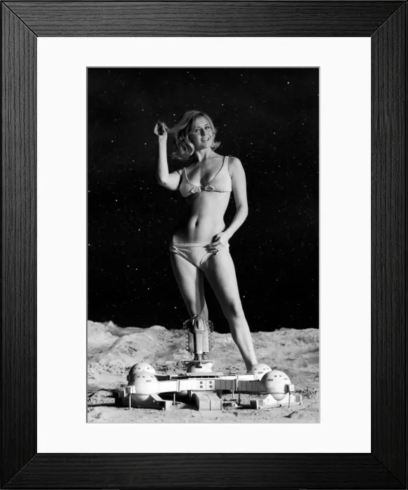 Framed Print : Model June Cooper poses for pictures with a backdrop designed as the surface of the moon Framed Print : Model June Cooper poses for pictures with a backdrop designed as the surface of the moon