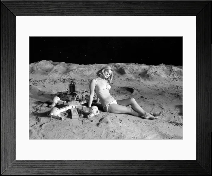 Framed Print : Model June Cooper poses for pictures with a backdrop designed as the surface of the moon Framed Print : Model June Cooper poses for pictures with a backdrop designed as the surface of the moon