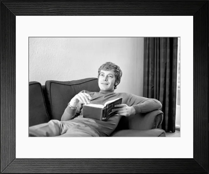 Framed Print : Families: Mother, father and children. Man relaxing at home, reading a book on his sofa Framed Print : Families: Mother, father and children. Man relaxing at home, reading a book on his sofa