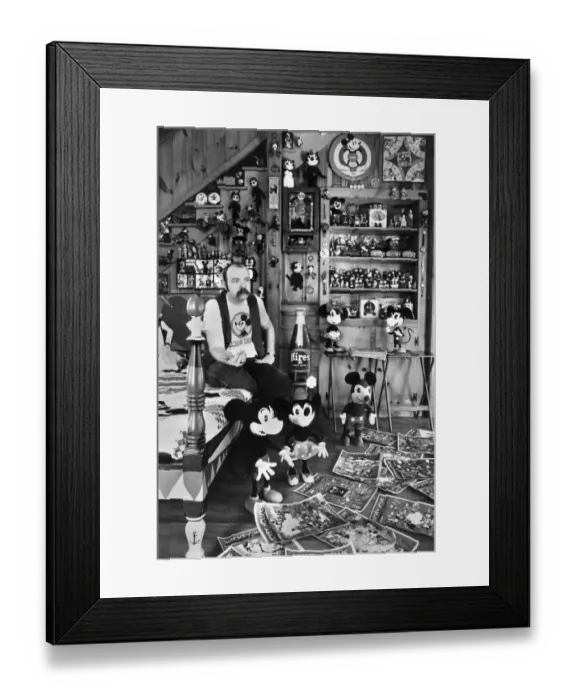 Framed Print : Collections. Mickey Mouse mania. Assistant Professor John Fawcett at his home