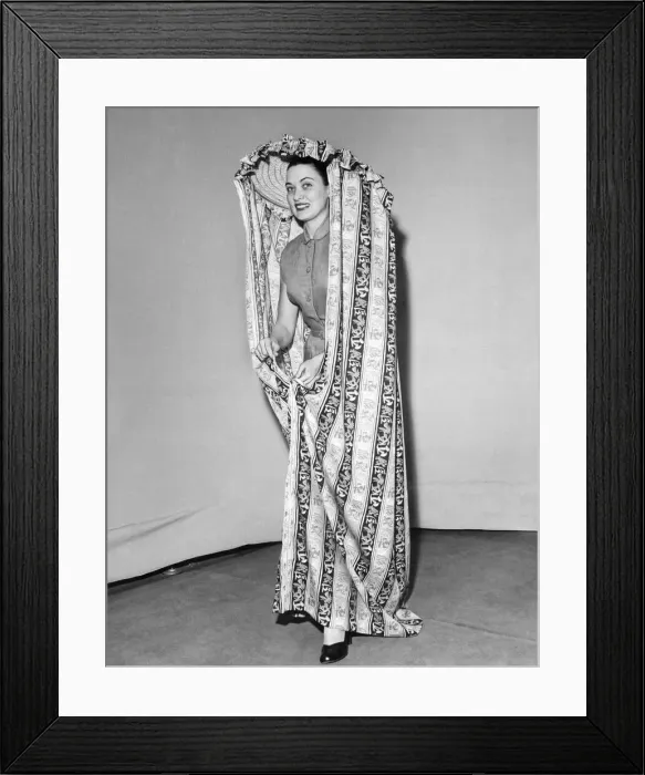 Framed Print : Model Julie Wilson wearing a printed mobile changing curtain June 1951 Framed Print : Model Julie Wilson wearing a printed mobile changing curtain June 1951