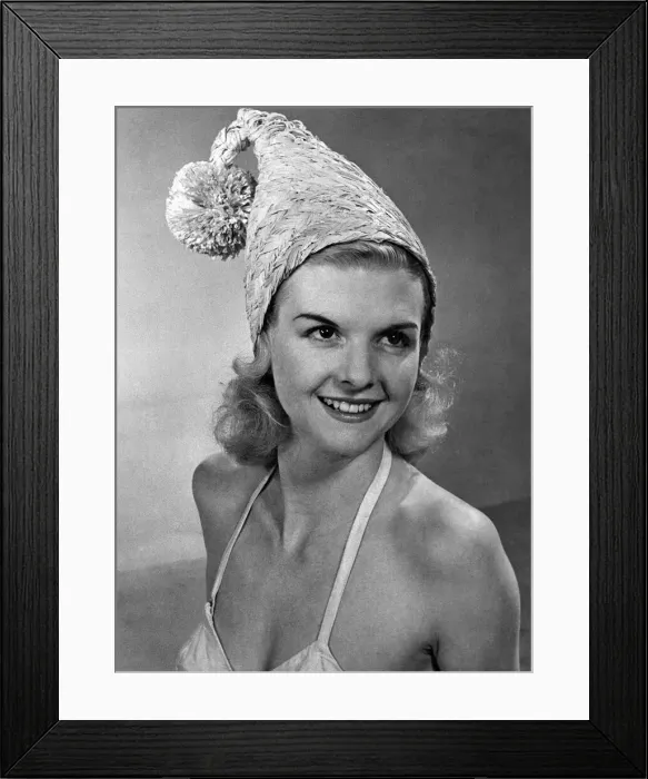 Framed Print : Woman wearing an unusual hat and bikini top April 1953 P017643