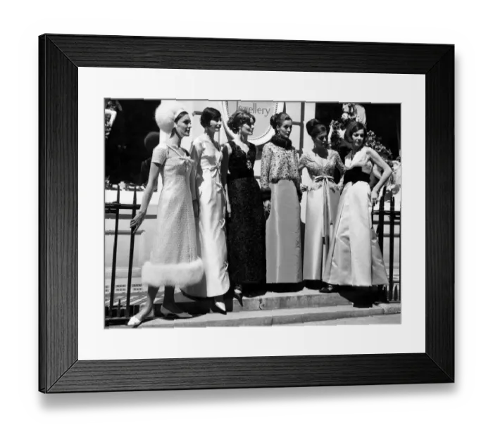 Framed Print : Fashion 1960s. Women gather in a group on the steps in street