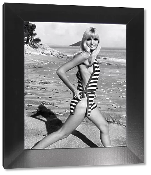 Woman wearing one piece swimsuit tied together at the sides January 1968