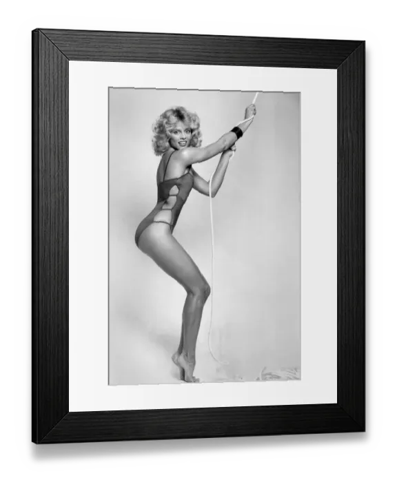 Framed Print : Woman wearing one piece swimsuit, pulling on a rope January 1982 P017666 Framed Print : Woman wearing one piece swimsuit, pulling on a rope January 1982 P017666