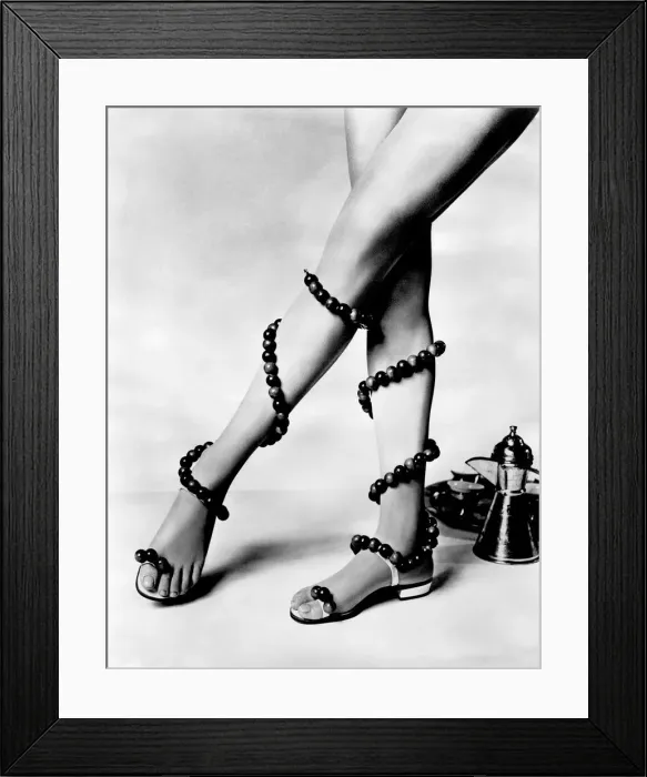 Framed Print : Woman wearing unusual pair of shoes with beads wrapped around her legs