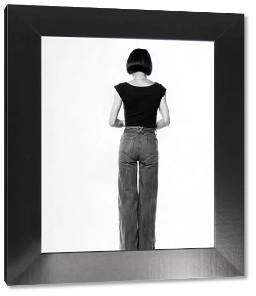 Fashion - 1970s. Back of woman. Jeans and t-shirt. October 1975 P017333